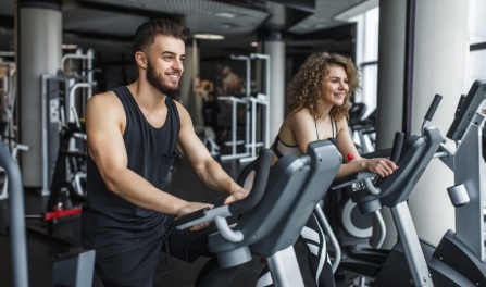 attractive-young-woman-her-trainer-running-treadmill-gym